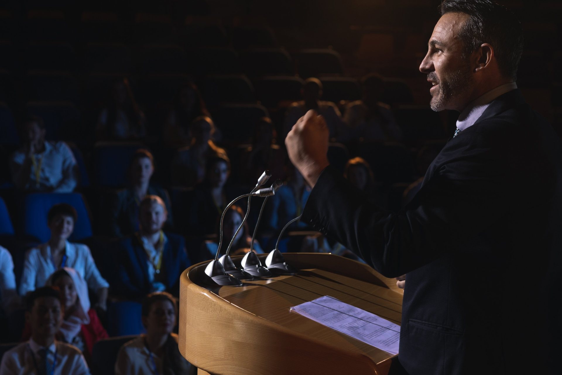 Business speaker presenting to an audience in a conference hall